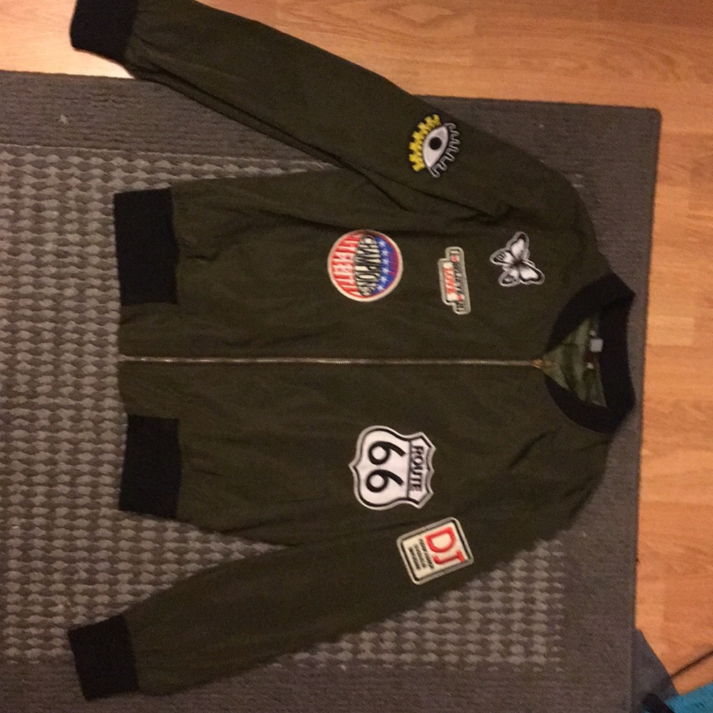 Dark green bomber jacket with patches.
